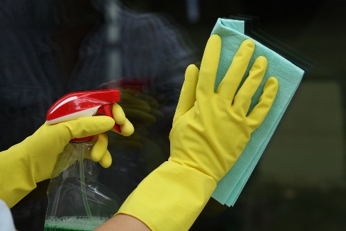 Local cleaner inspecting a sofa fabric in SE3